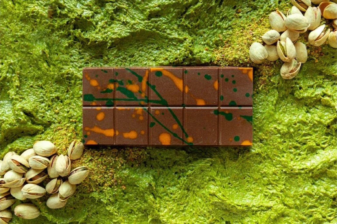 FIX Dessert Chocolatier Can’t Get Knafeh of It Dubai chocolate bar, splatter-decorated milk chocolate on a bed of pistachio cream with pistachios